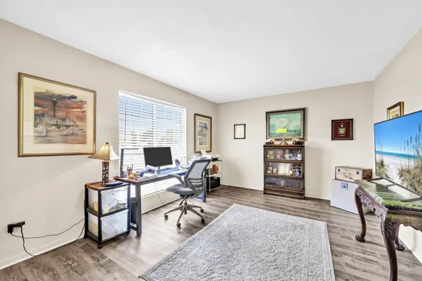 a view of a livingroom with workspace and a window