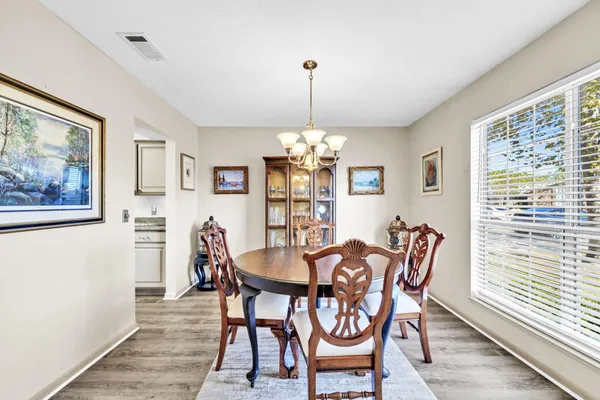 a view of a dining room with furniture window and wooden floor