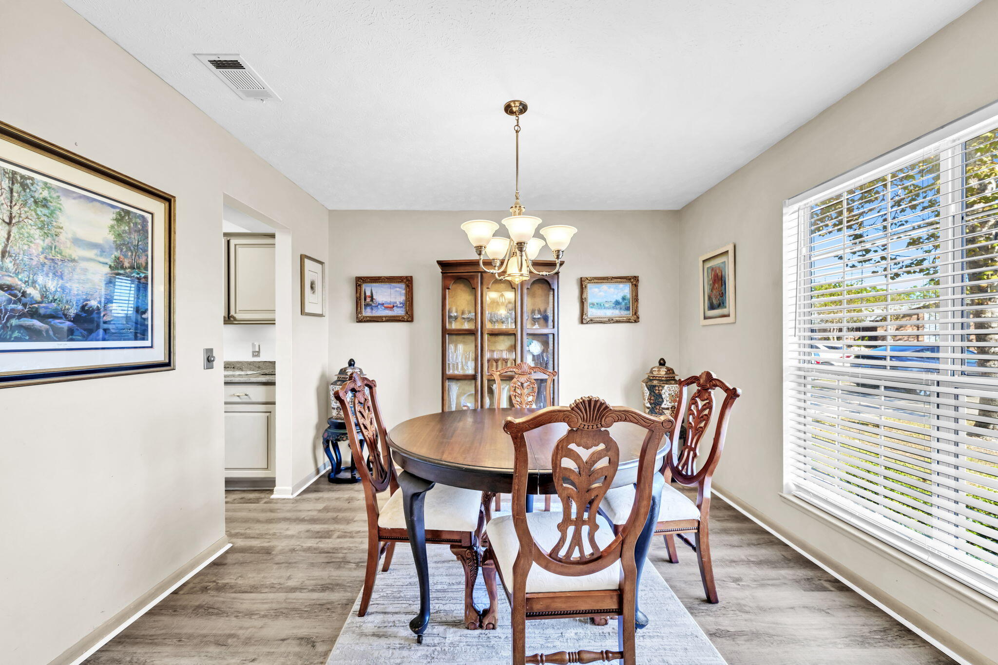2609 Briarcliff Road Panama City, FL 32405 - Photo 13 of 41 a dining room with furniture a chandelier and wooden floor
