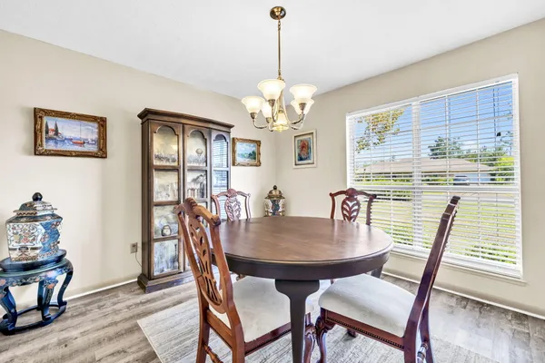 a view of a dining room with furniture and wooden floor