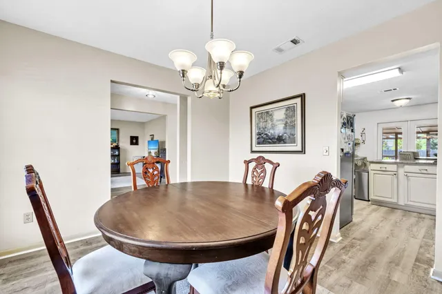 a kitchen with granite countertop stainless steel appliances white cabinets sink and dishwasher
