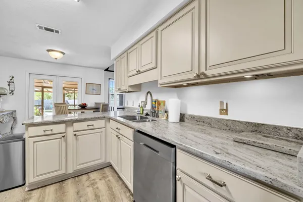 a kitchen with stainless steel appliances granite countertop a sink and cabinets