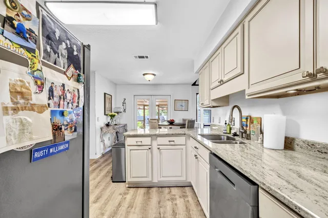 a kitchen with stainless steel appliances granite countertop a refrigerator sink and cabinets