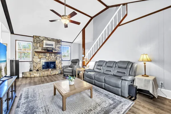 a living room with furniture fireplace and a flat screen tv