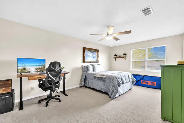 a bedroom with a bed and a chandelier