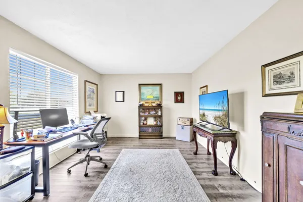 a view of a livingroom with workspace and a window