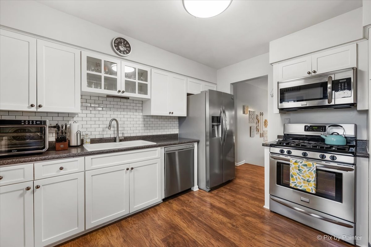 647 North Ridgemoor Avenue Mundelein, IL 60060 - Photo 13 of 39 a kitchen with stainless steel appliances a stove a sink and wooden cabinets