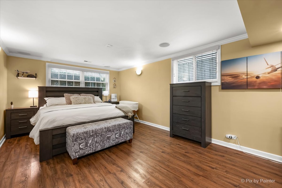 647 North Ridgemoor Avenue Mundelein, IL 60060 - Photo 14 of 39 a bedroom with a bed and wooden floor