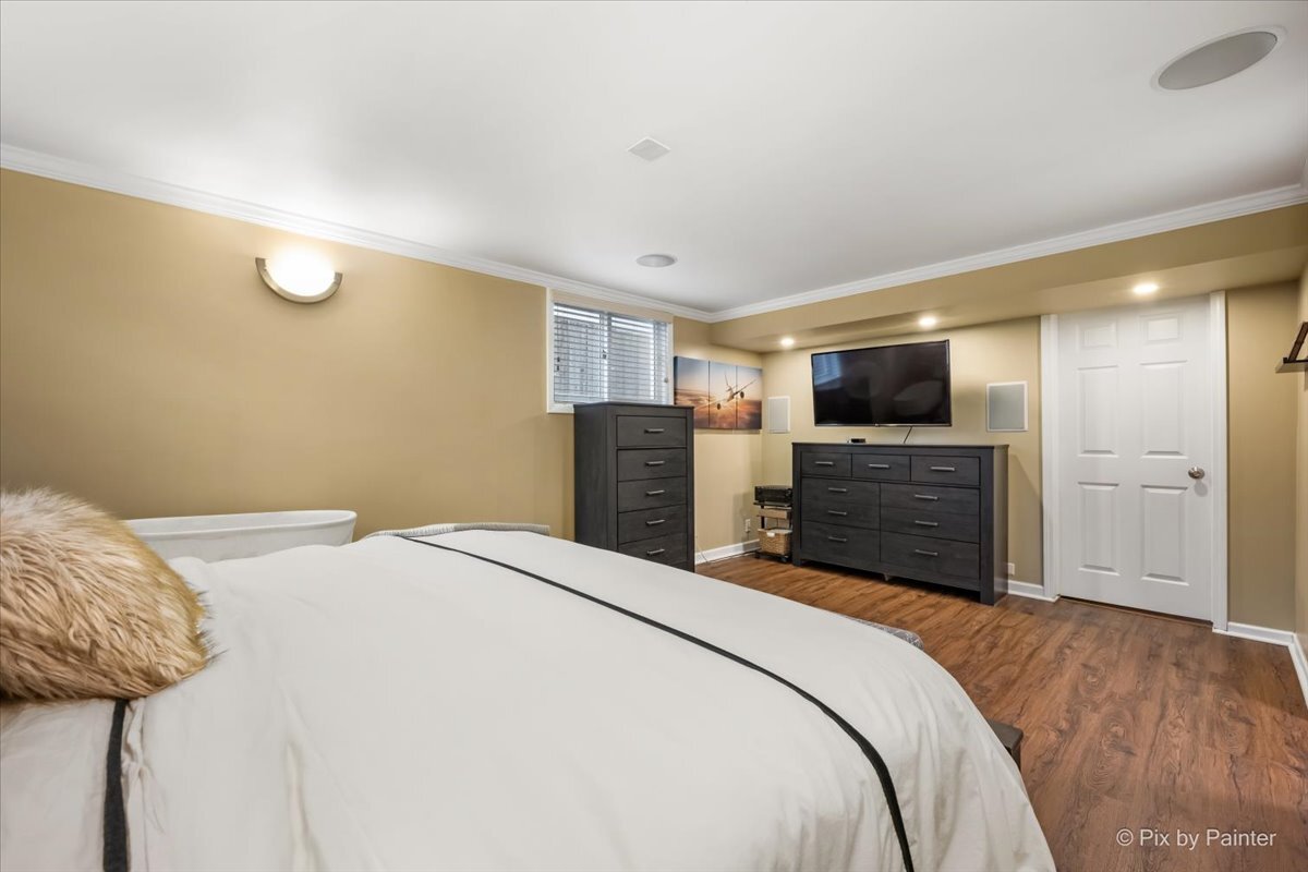 647 North Ridgemoor Avenue Mundelein, IL 60060 - Photo 16 of 39 a bedroom with a bed and a television