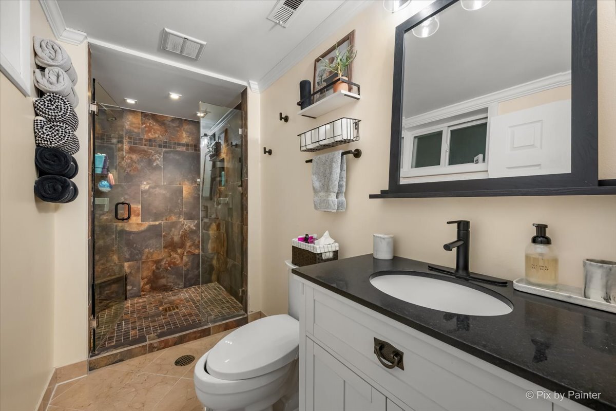 647 North Ridgemoor Avenue Mundelein, IL 60060 - Photo 18 of 39 a bathroom with a granite countertop sink toilet mirror and shower