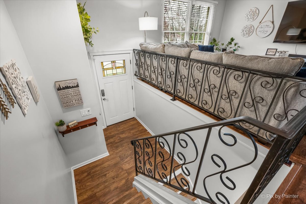 647 North Ridgemoor Avenue Mundelein, IL 60060 - Photo 4 of 39 a view of a hallway with wooden floor and stairs