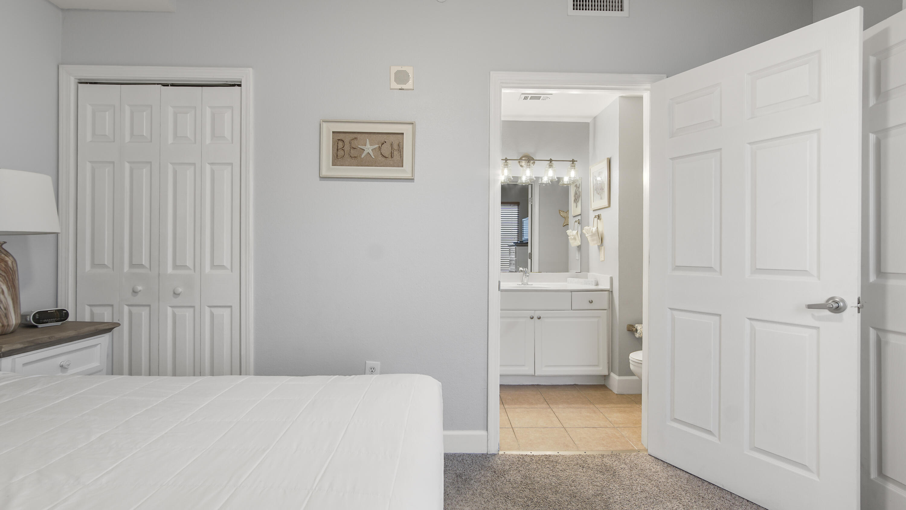 16819 Front Beach Road, Unit 1810 Panama City Beach, FL 32413 - Photo 22 of 54 a hallway with a bathroom
