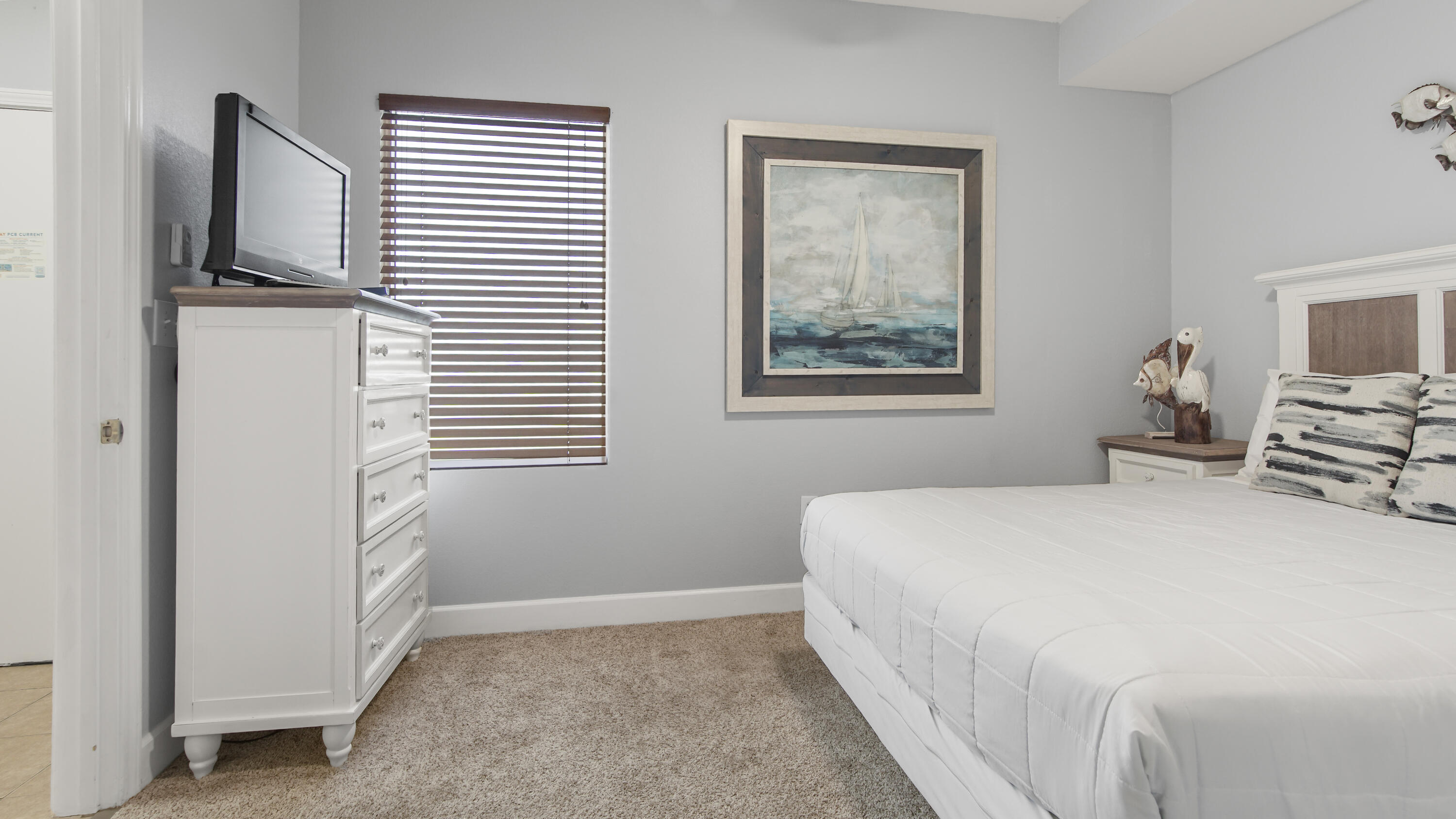 16819 Front Beach Road, Unit 1810 Panama City Beach, FL 32413 - Photo 25 of 54 a bedroom with a bed and a flat screen tv