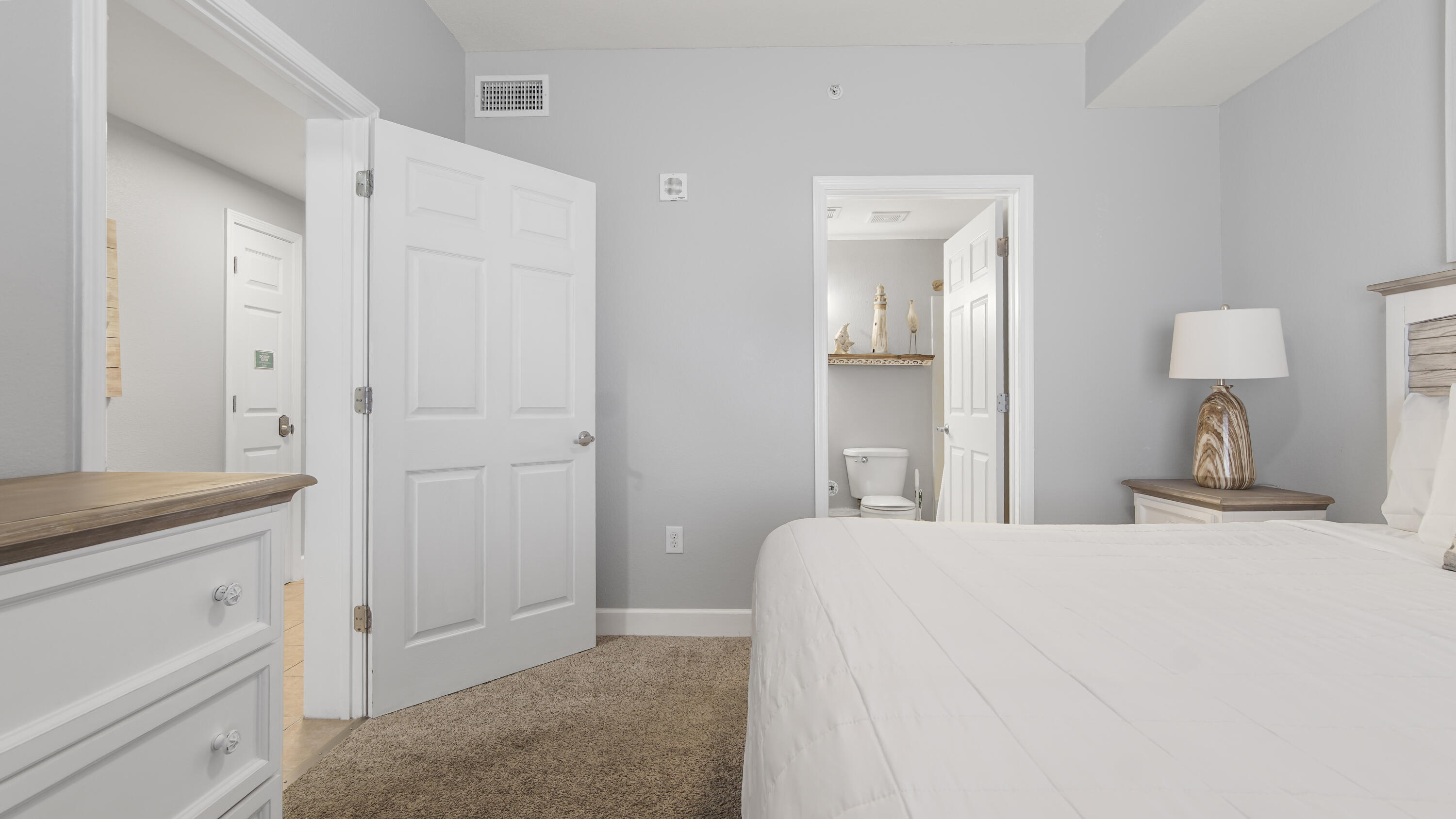 16819 Front Beach Road, Unit 1810 Panama City Beach, FL 32413 - Photo 27 of 54 a bedroom with a bed and a mirror