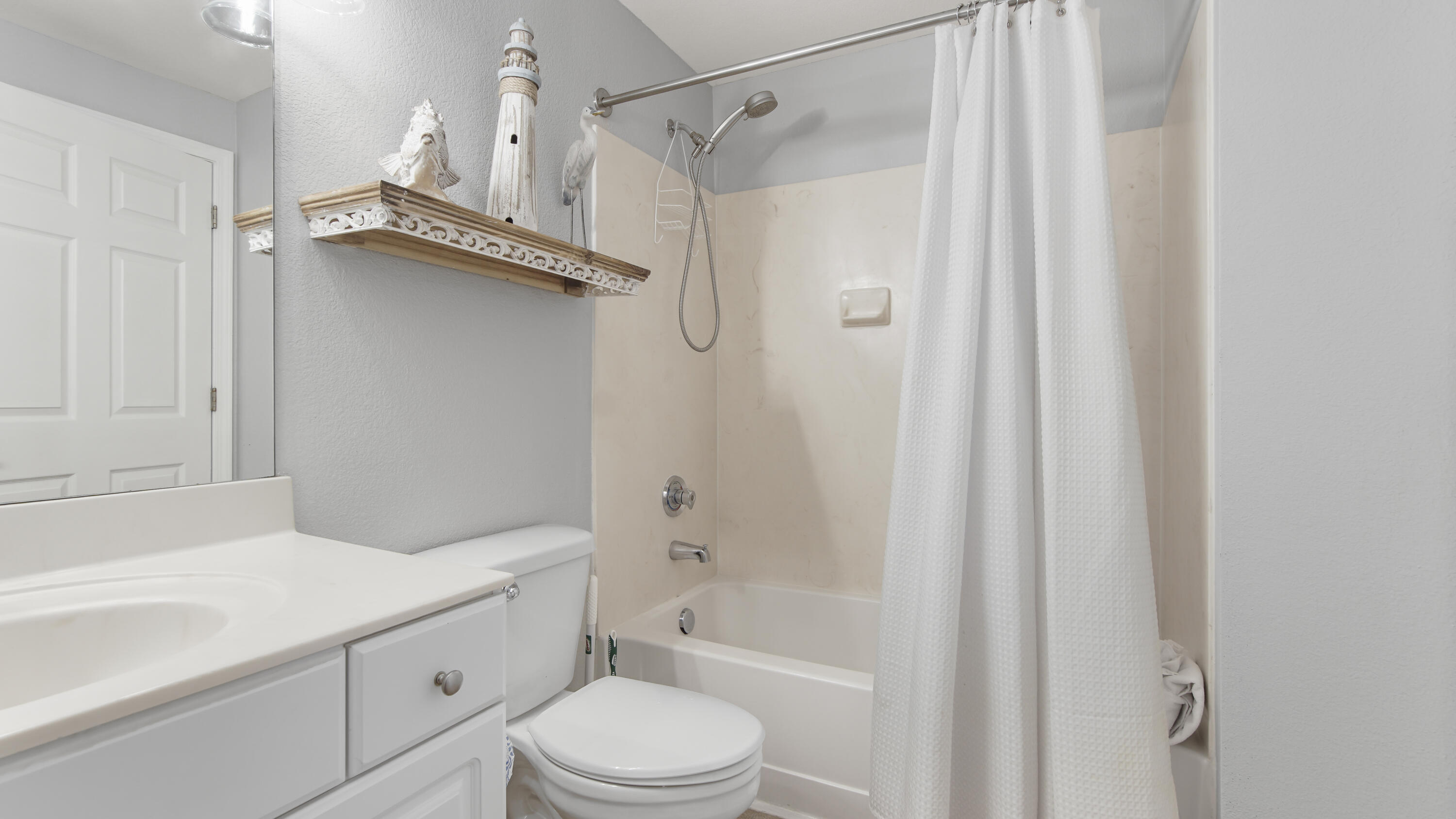 16819 Front Beach Road, Unit 1810 Panama City Beach, FL 32413 - Photo 29 of 54 a bathroom with a shower a toilet and a sink