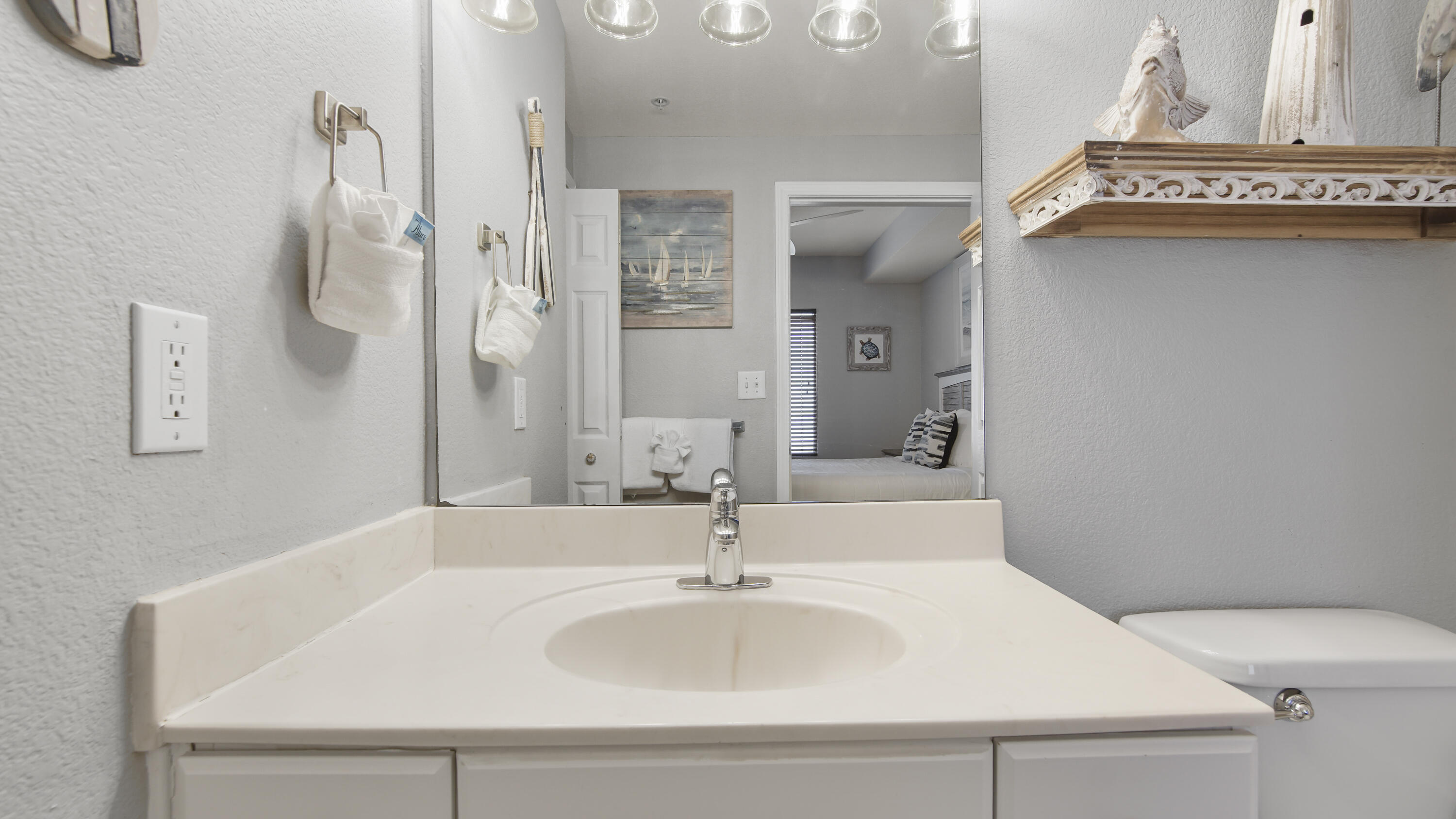 16819 Front Beach Road, Unit 1810 Panama City Beach, FL 32413 - Photo 30 of 54 a bathroom with a sink and a mirror