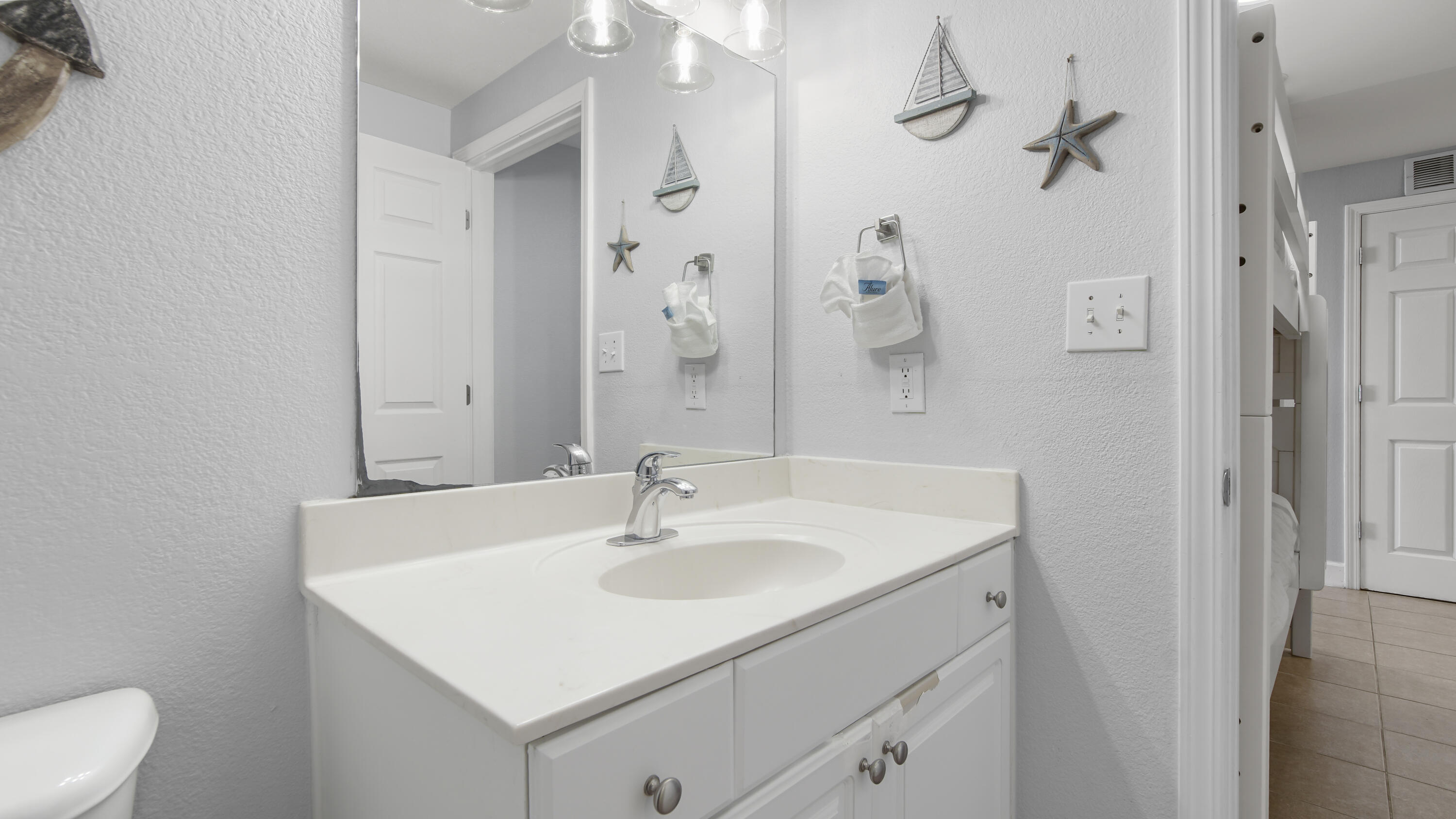 16819 Front Beach Road, Unit 1810 Panama City Beach, FL 32413 - Photo 34 of 54 a bathroom with a sink a toilet and shower