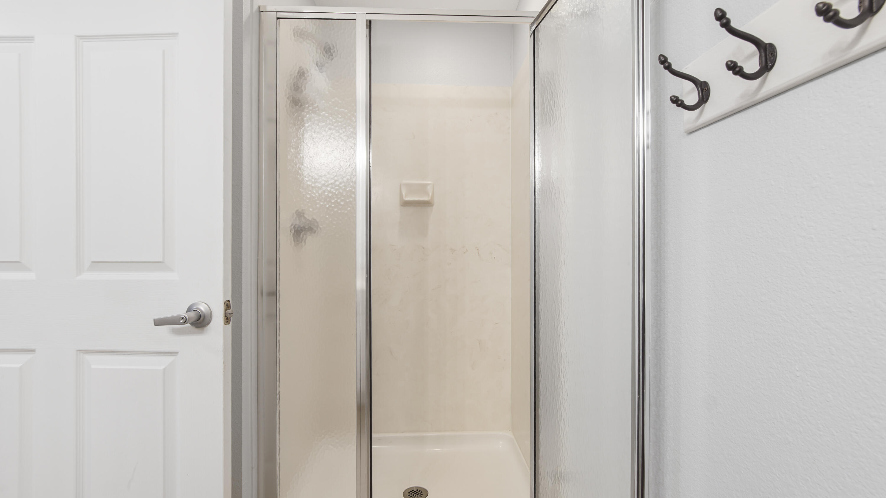 16819 Front Beach Road, Unit 1810 Panama City Beach, FL 32413 - Photo 35 of 54 a bathroom with a glass shower door