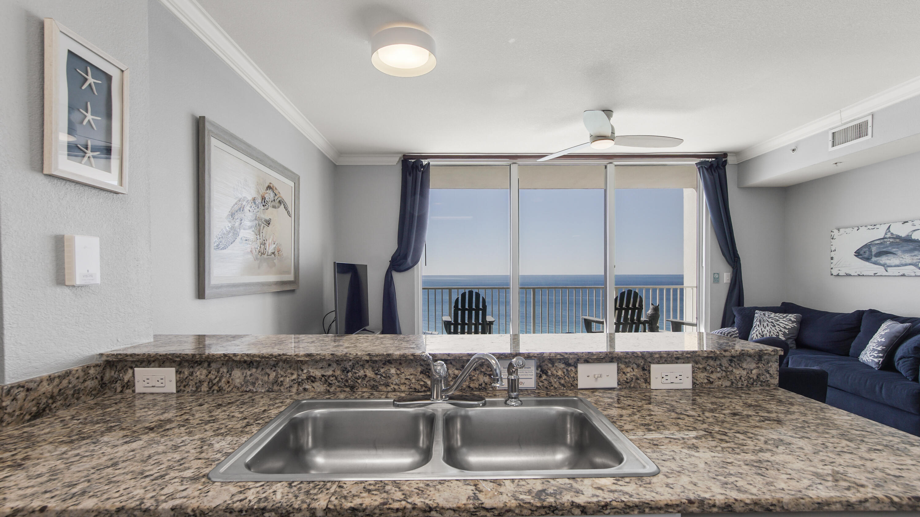 16819 Front Beach Road, Unit 1810 Panama City Beach, FL 32413 - Photo 39 of 54 a kitchen with stainless steel appliances granite countertop a sink a stove and a wooden floors