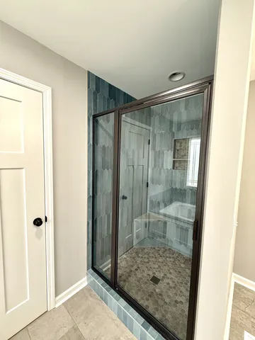 a bathroom with a glass shower door