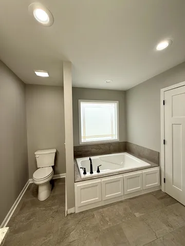 a bathroom with a bathtub and a toilet
