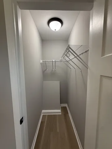 a view of room with hardwood floor and ceiling fan