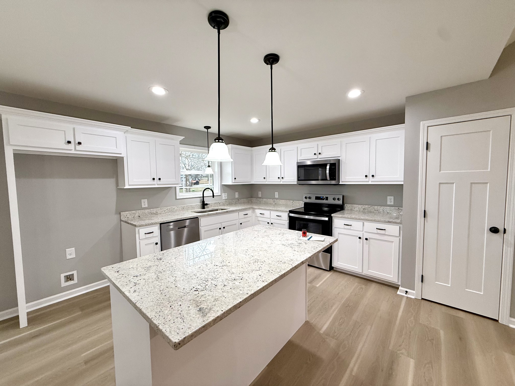 52 Wiseman Lane Winchester, TN 37398 - Photo 7 of 30 a kitchen with kitchen island a sink stainless steel appliances and white cabinets