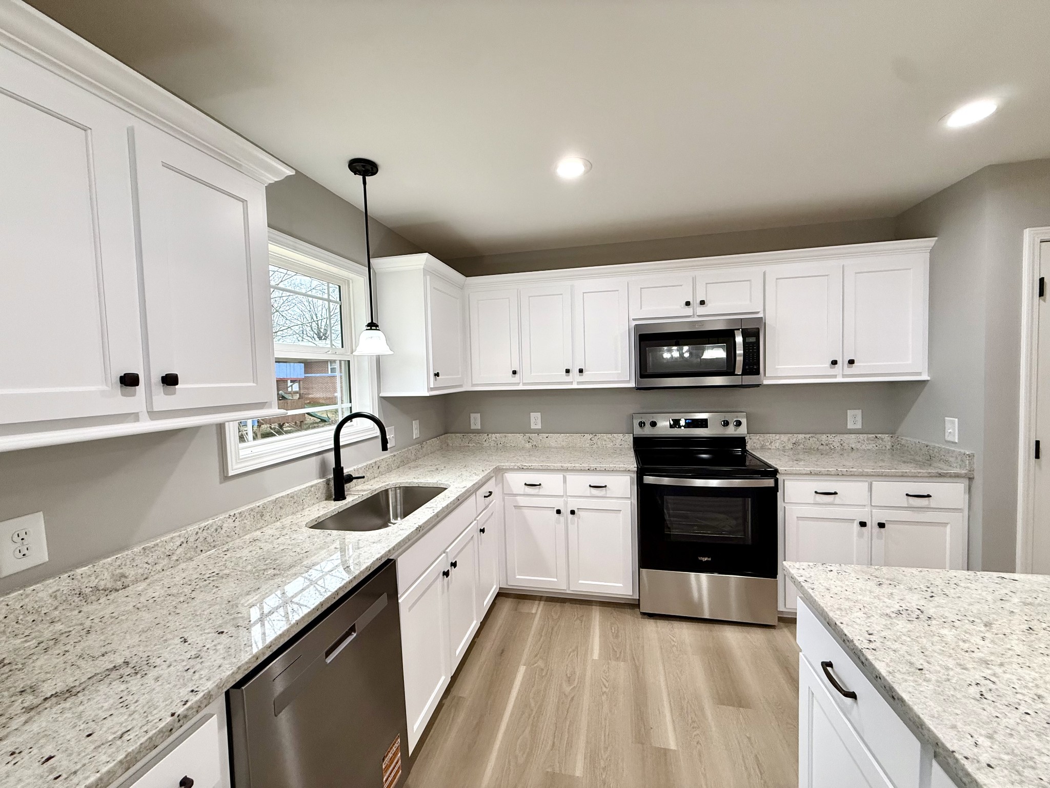 52 Wiseman Lane Winchester, TN 37398 - Photo 8 of 30 a kitchen with granite countertop a sink a stove and cabinets