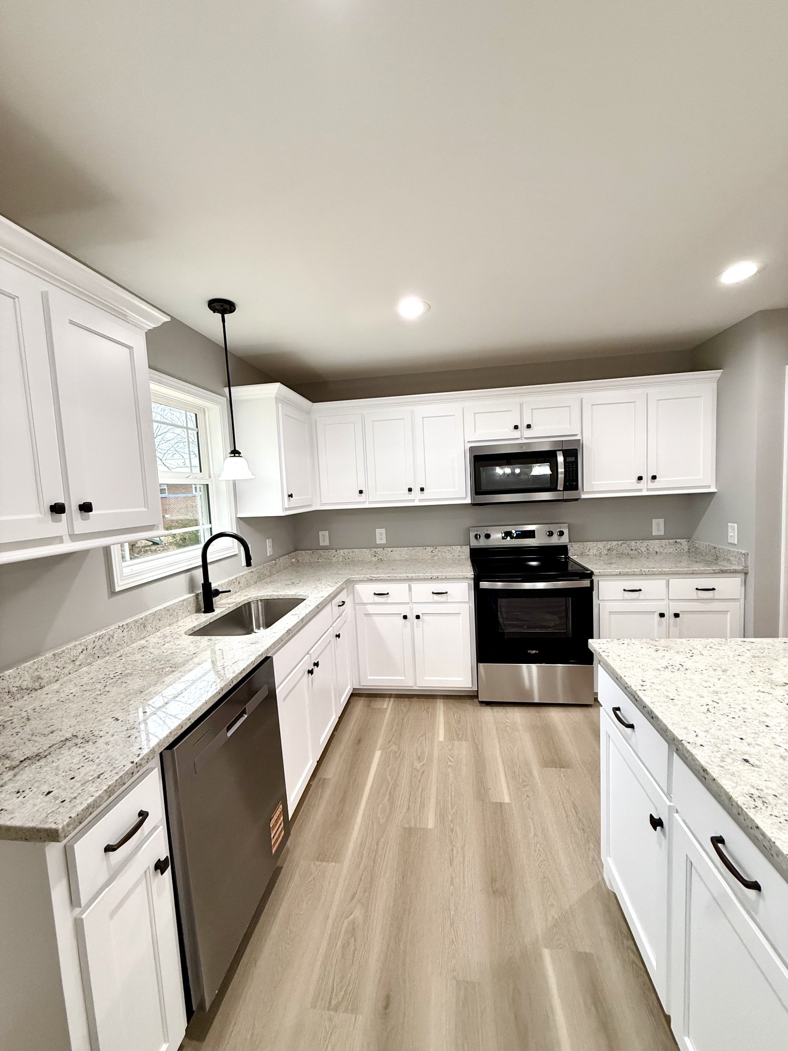 52 Wiseman Lane Winchester, TN 37398 - Photo 9 of 30 a large kitchen with a stove top oven a sink a microwave and cabinets