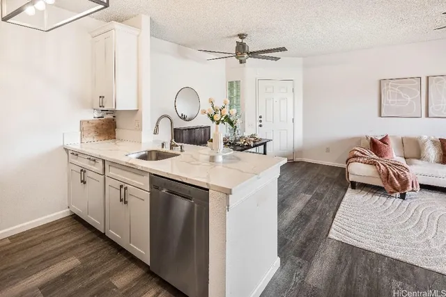 a kitchen with a sink cabinets and wooden floor