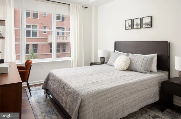 a bedroom with a bed and a table