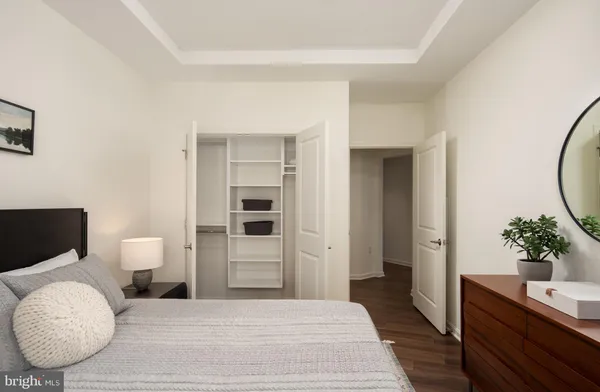 a bedroom with a bed and a potted plant