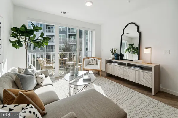 a living room with furniture and potted plant
