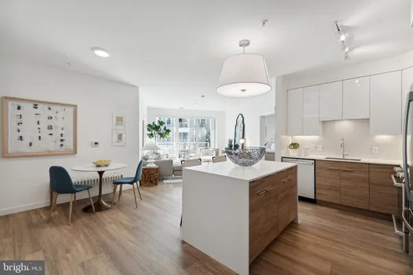 a kitchen with sink cabinets and wooden floor