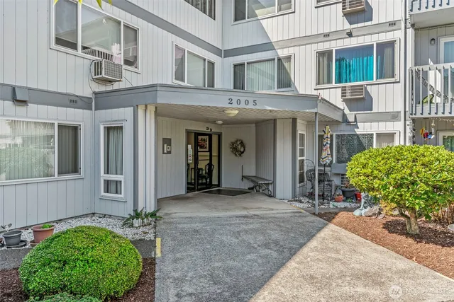 a view of a house with potted plants in front of door