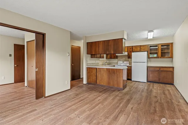 a kitchen with refrigerator and cabinets