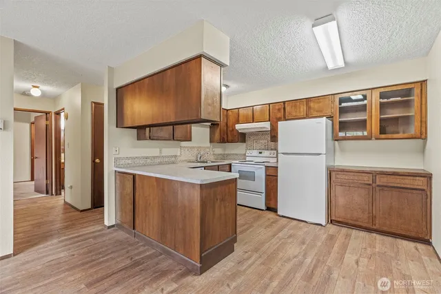 a kitchen with a sink a refrigerator and a stove