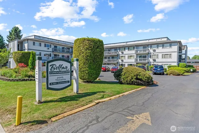 a front view of a house with garden and plants