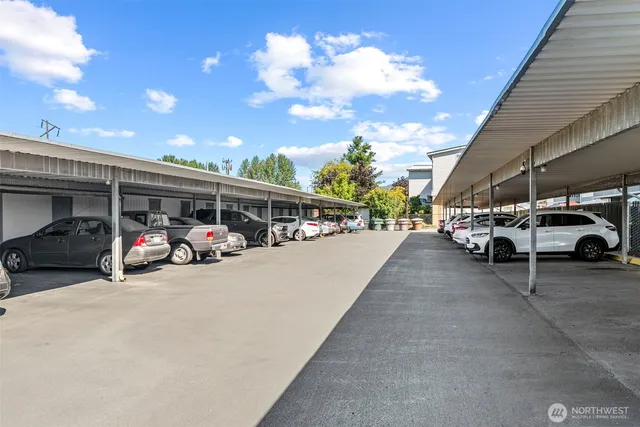 a dining room with furniture and a floor to ceiling window