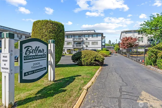 a view of a street with potted plants