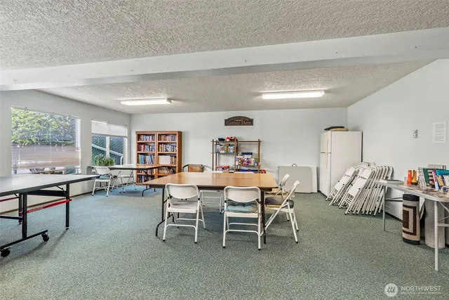 a living room with furniture and a dining table with wooden floor