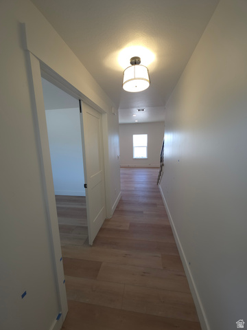 1267 West 2350 South Perry, UT 84302 - Photo 11 of 20 Hallway featuring wood-finish flooring, recessed lighting, and a drum pendant light fixture