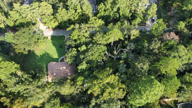 an aerial view of a house with a yard and outdoor seating