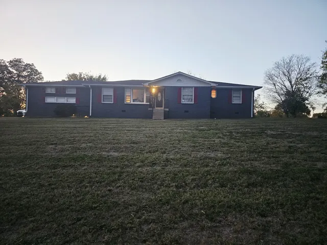 a view of a brick house with a big yard