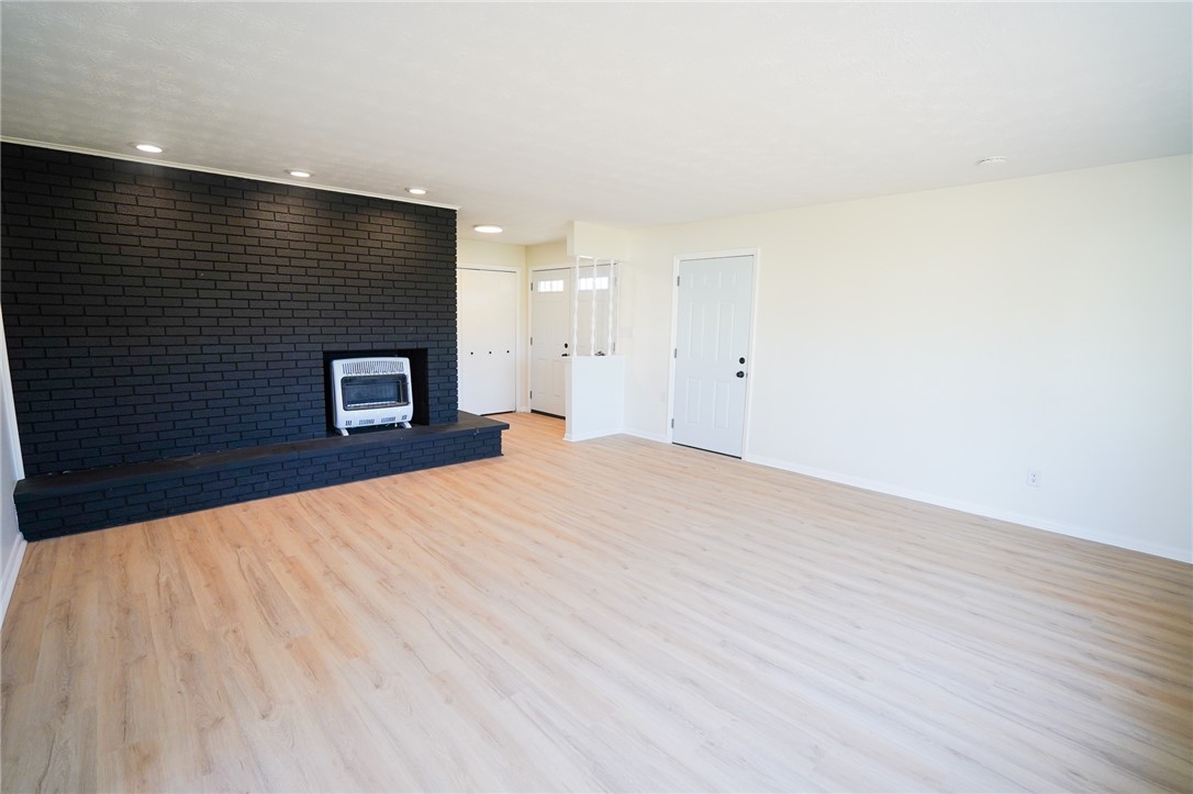 8746 Grubbs-Rex Road Arcanum, OH 45304 - Photo 21 of 38 This bright living area features modern flooring and a captivating brick fireplace.