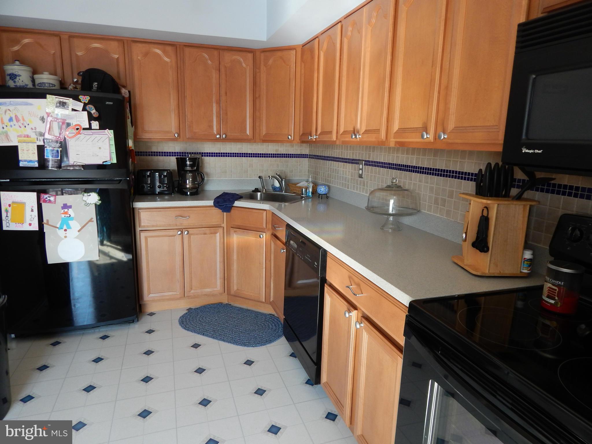 1591 Lynch Road Baltimore, MD 21222 - Photo 8 of 22 a kitchen with stainless steel appliances a stove a sink and a microwave