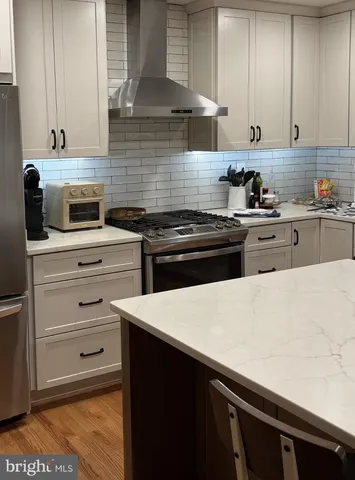 a kitchen with granite countertop cabinets and appliances