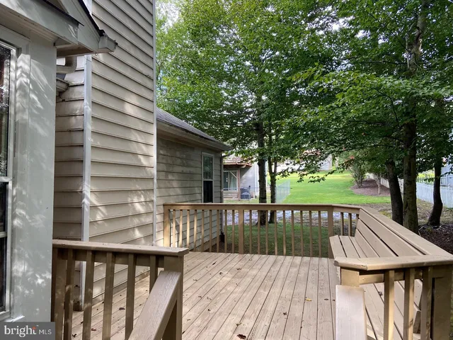 a view of house with a deck and furniture