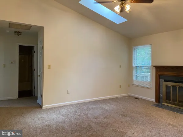 a view of empty room with a fireplace