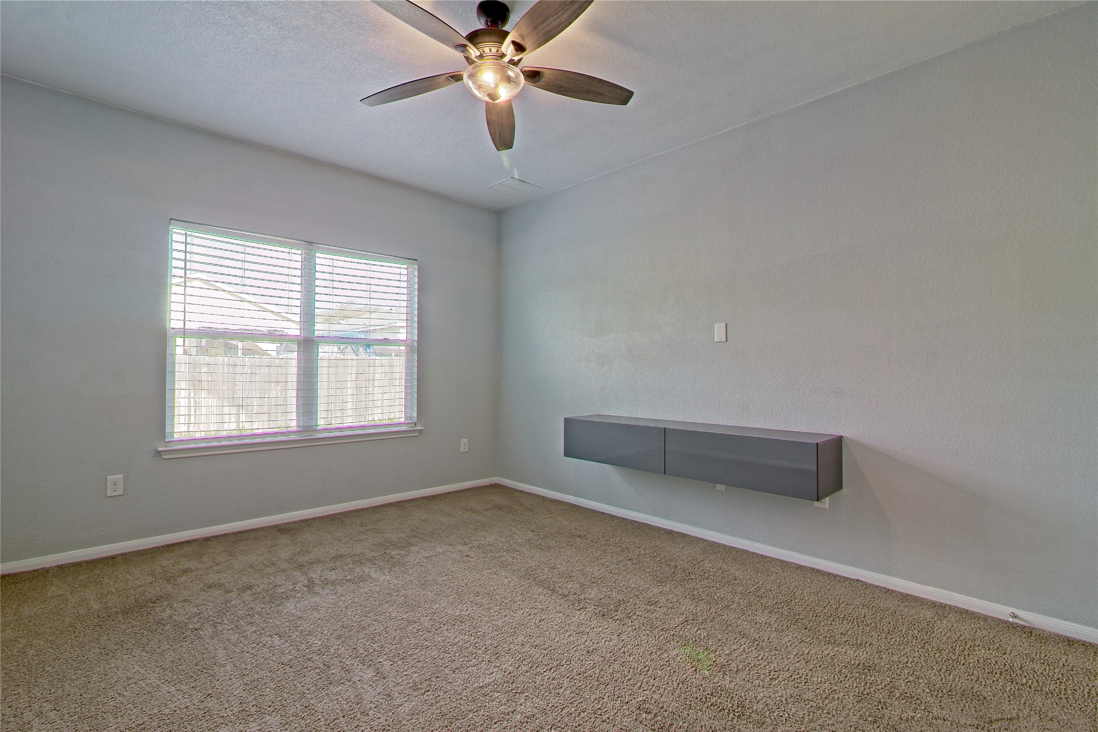 3408 Tilmon Ln. Austin, TX 78725 - Photo 20 of 35 Carpeted empty room featuring baseboards and a ceiling fan